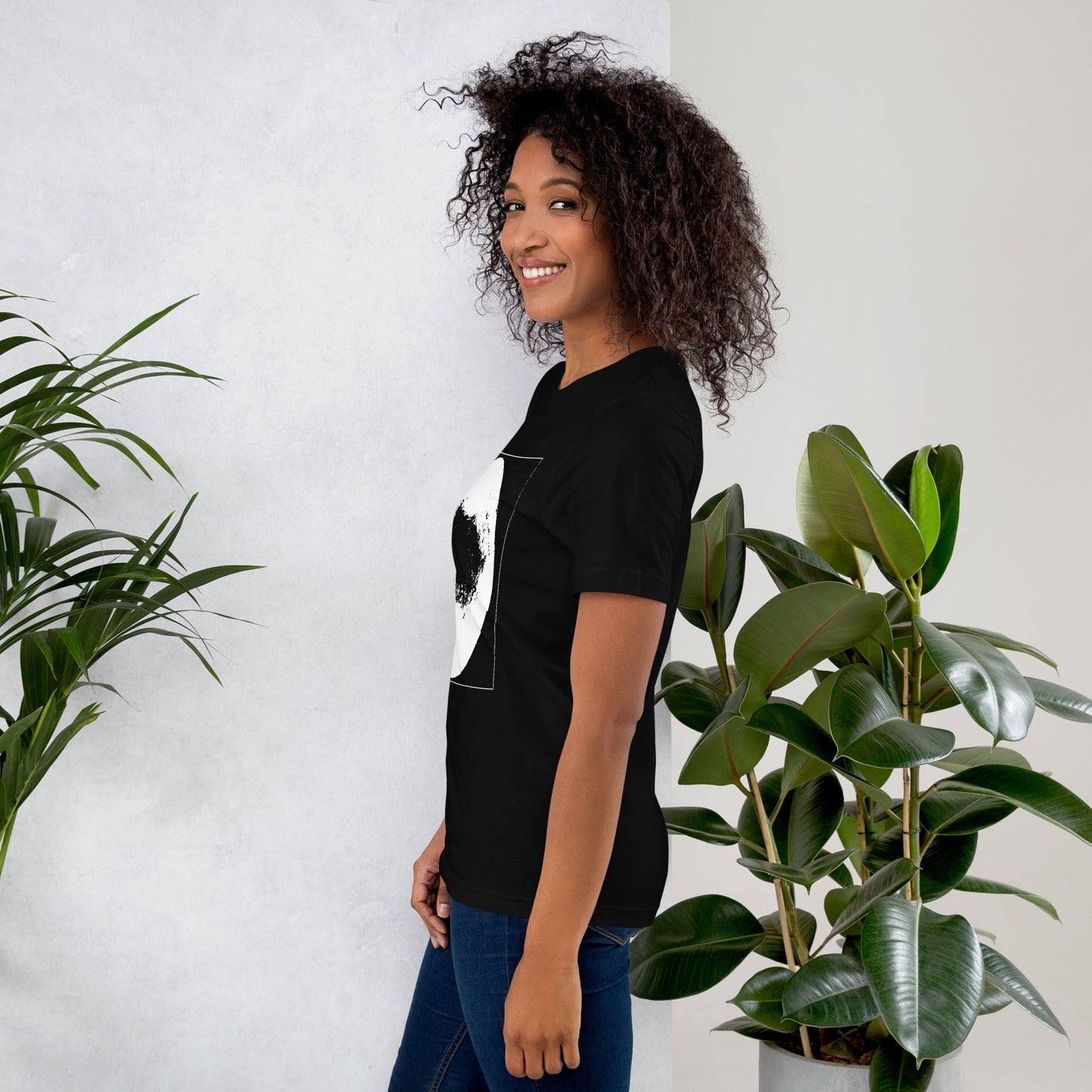 Side view of woman wearing black cotton graphic t-shirt