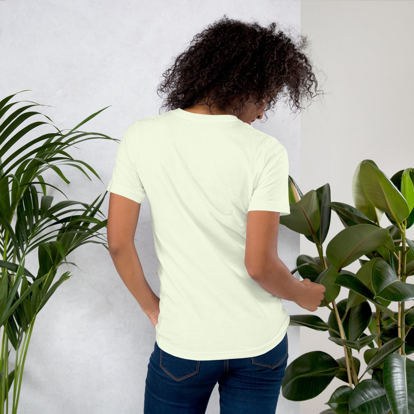 Back view of woman wearing citron color cotton graphic t-shirt