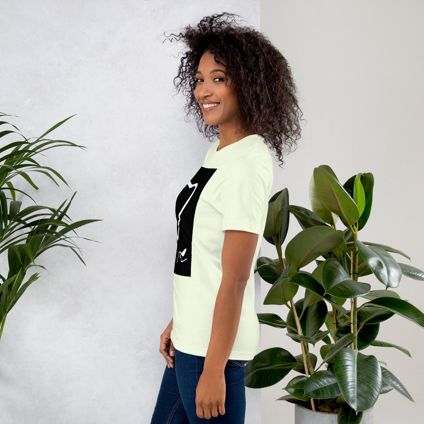 Side view of woman wearing citron color cotton graphic t-shirt