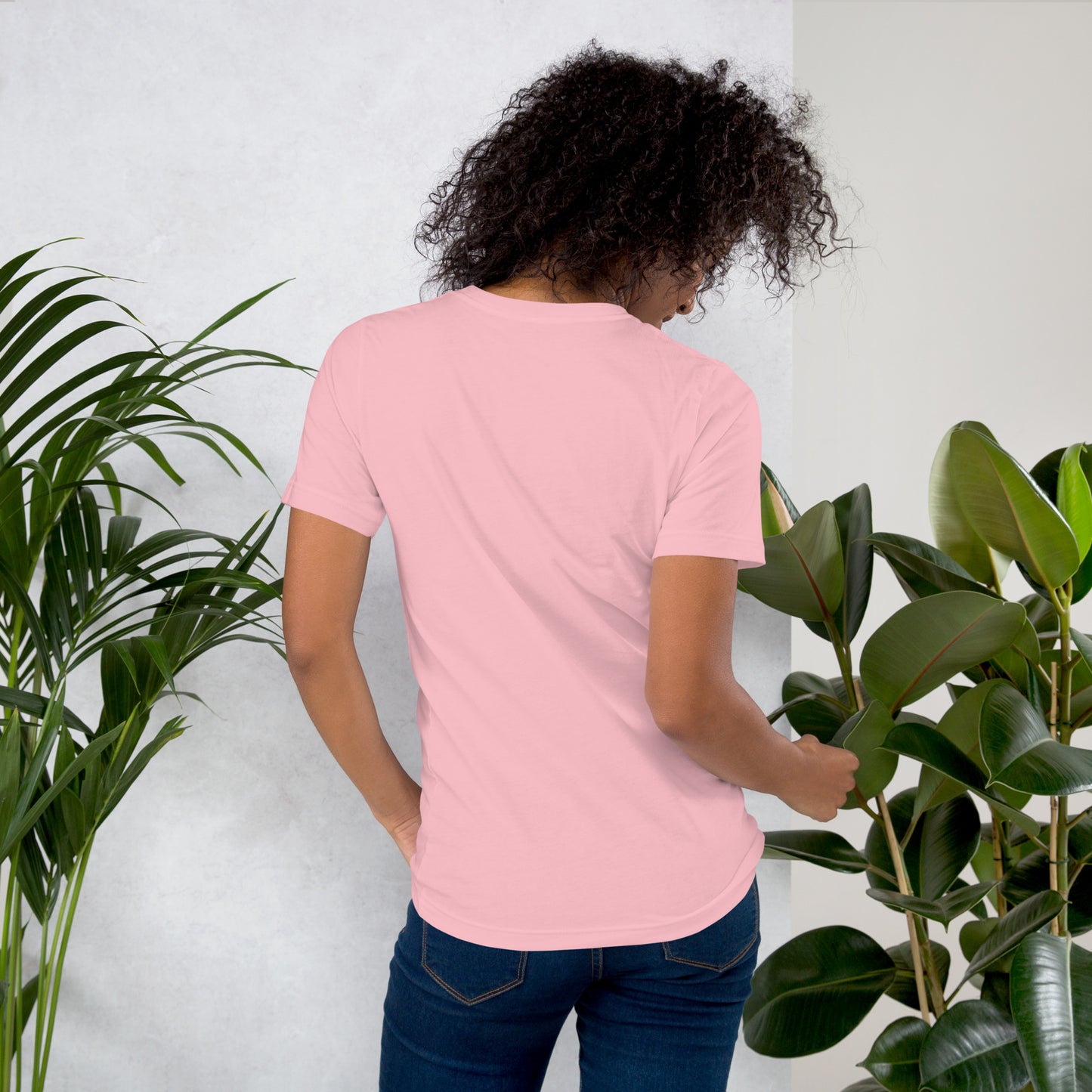 Back view of woman wearing coral cotton graphic t-shirt