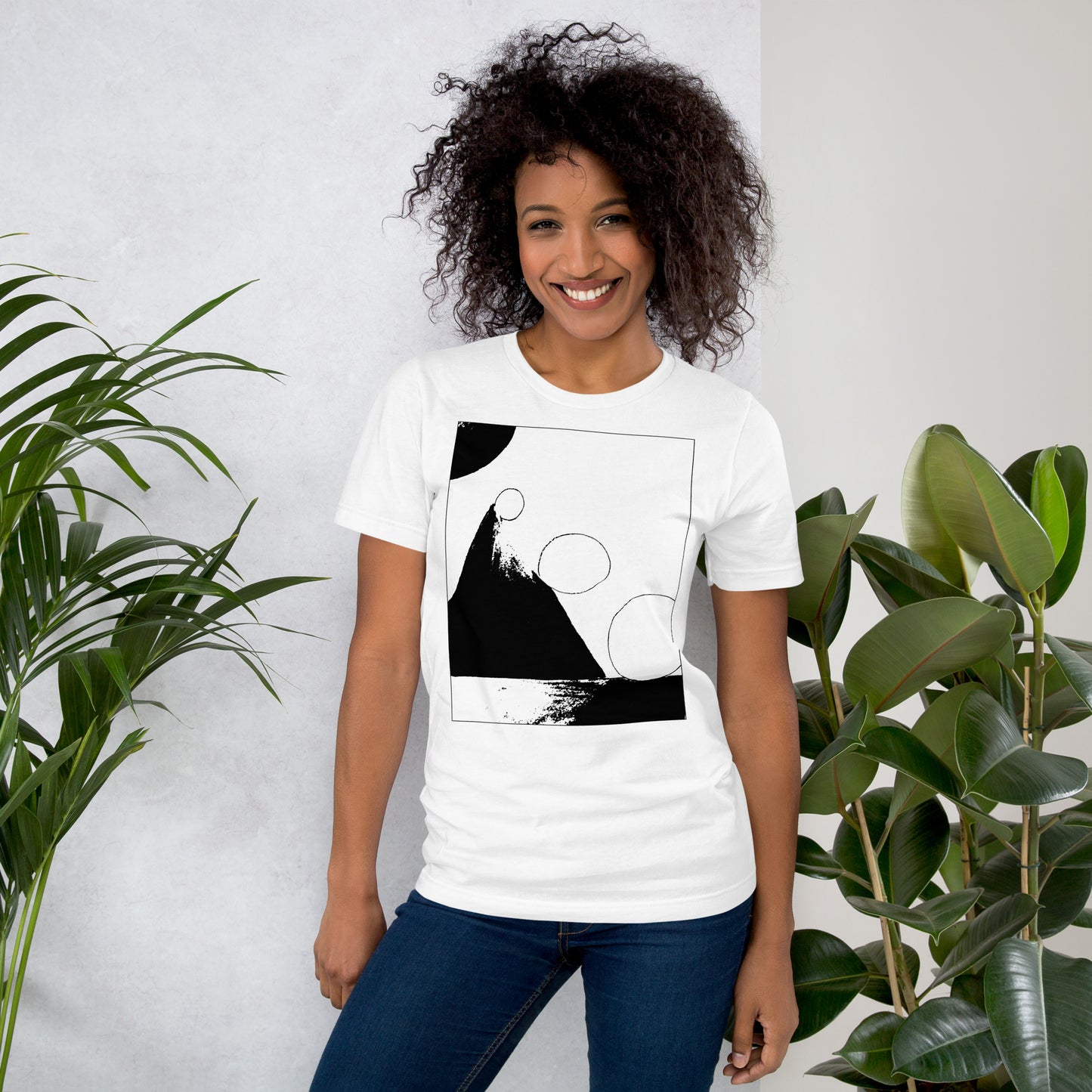 Woman wearing white cotton graphic t-shirt with black abstract pyramid artwork in a thin black square on front