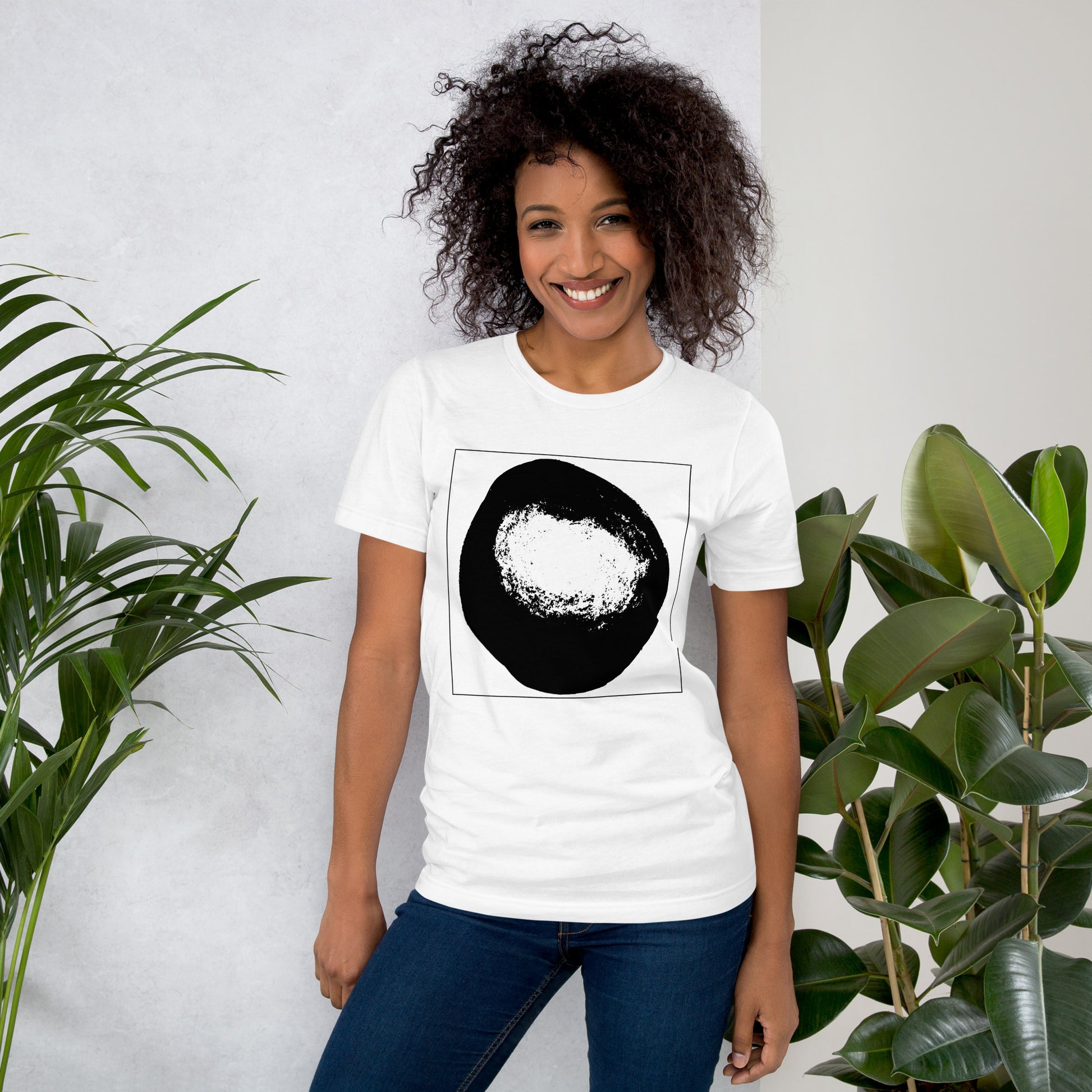 Woman wearing a white cotton graphic t-shirt with black abstract dome artwork in a thin black square on front