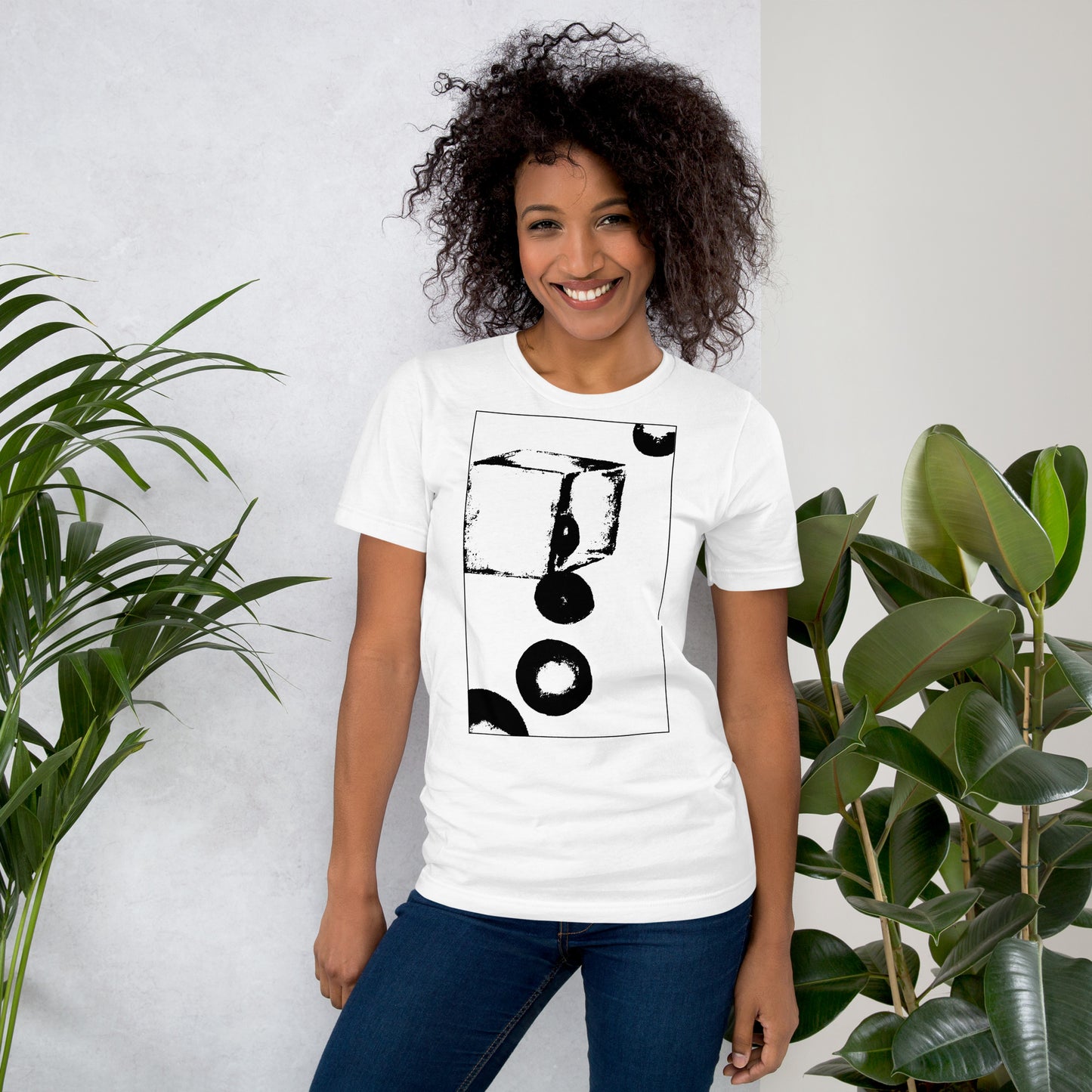 Woman wearing white cotton graphic t-shirt with black abstract cube and spheres artwork in a thin black square on front